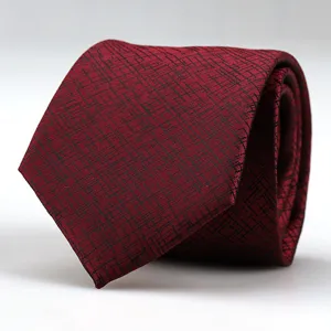 Red men's business formal necktie with abstract black pattern, fine fabric detail shot.