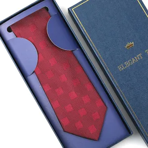 Red men's dress necktie with geometric pattern in a blue gift box for wedding business.
