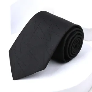Close up of black geometric pattern tie detail showing fabric texture and fine workmanship