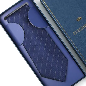Close-up detail of a navy blue striped necktie neatly presented in an elegant gift box.