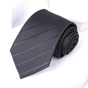 Dark grey striped men's necktie detail, classic formal business wear closeup view.