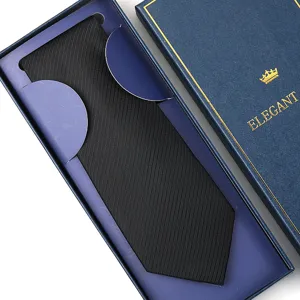 Detailed closeup of a classic black men's necktie neatly arranged in an elegant blue gift box.