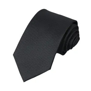 Classic black men's formal necktie rolled up, elegant business wear accessory for wedding.