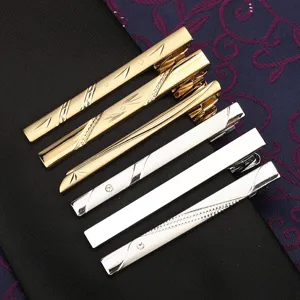 Men's business metal tie clip set, gold and silver fashion suit accessories detail.