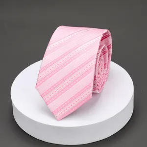 Detailed closeup of a pink patterned necktie featuring elegant geometric stripes and subtle diamond motifs.