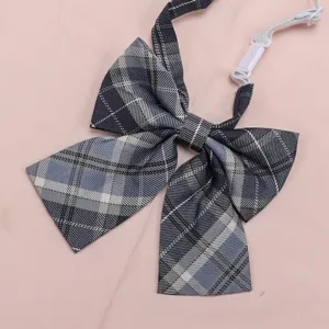 Close up view of the blue plaid JK uniform bowtie detail, featuring adjustable strap.