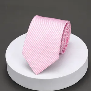 Close-up detail of elegant pink and white striped necktie neatly rolled on a white display stand.