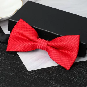 Detailed close-up view of a vibrant red men's bow tie featuring textured fabric design.