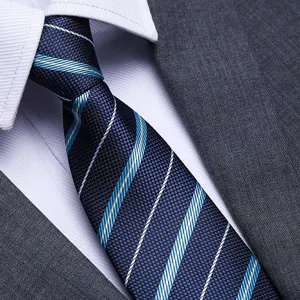 Detailed close-up of a stylish men's blue striped business tie, paired with crisp shirt.
