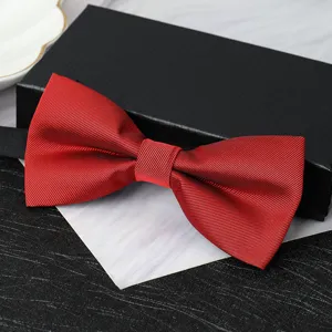 Close-up detail of a classic men's burgundy double layer bow tie for formal wear.