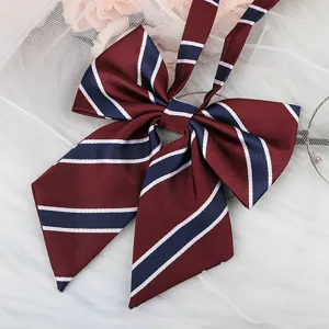 Detailed close-up view of the maroon JK uniform ribbon bow featuring classic stripe design.