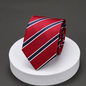 Detail close-up of a classic red business tie with stylish dark blue and white diagonal stripes.