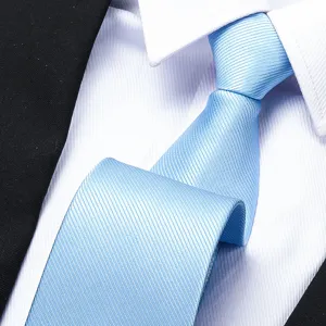 Detailed close-up of a stylish light blue striped business necktie paired with a white dress shirt.
