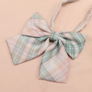 Detailed close-up shot of pastel pink and green plaid JK uniform bow tie accessory.