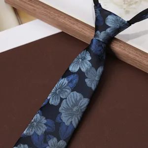 Close-up detail of blue floral pattern necktie, elegant fabric texture for men formal wear.
