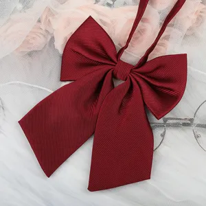 Burgundy JK bow tie detail close-up, classic college style ribbon accessory for shirts.