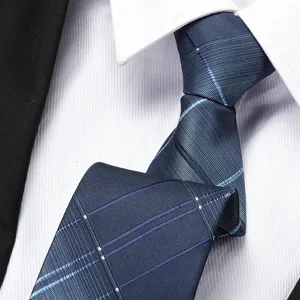 Close-up detail of a dark blue striped patterned tie, showing fine fabric texture and neat knot.
