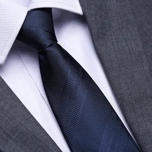 Close-up detail of men's blue striped business necktie matched with white shirt and suit.