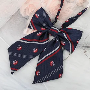 Detailed view of dark blue JK uniform bow tie with red white stripes and embroidery.