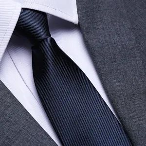 Close-up of men's navy blue textured business tie detail, premium fabric and formal wear design.