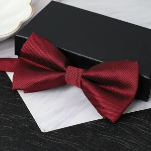 Burgundy striped bow tie detail view, elegant formal wear accessory for weddings and events.