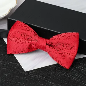 Red patterned bow tie detail showing exquisite textured fabric, perfect for formal wedding suits.