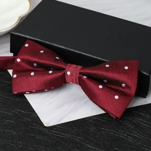 Burgundy polka dot bow tie detail shot showcasing fabric texture and elegant craft.