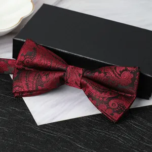 Detailed close-up of a burgundy paisley bow tie for men, elegant wedding formal wear accessory.