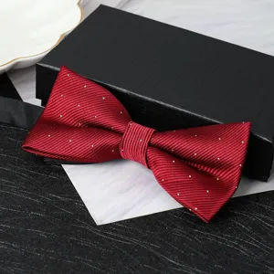 Close-up detail of the burgundy polka dot bow tie, showing fine fabric texture and fold.