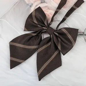 Dark brown plaid JK uniform bow tie detail shot, exquisite striped border ribbon accessory.
