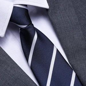 Close-up detail of a classic men's navy blue striped business tie with suit and shirt.
