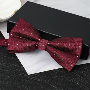 Wine red polka dot double layer bow tie for men, formal wedding suit accessory detail shot.