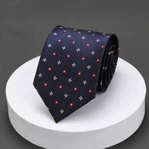 Detailed view of a classic dark blue men's business necktie with red and white cross pattern.
