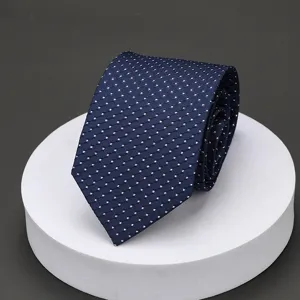 Detailed view of a classic blue business tie featuring a fine white patterned texture nicely folded.
