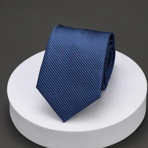Men's blue textured business tie detail view, professional formal wear accessory for wedding work.