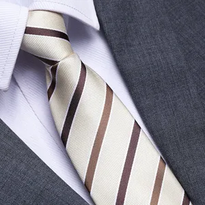 Close-up detail of a classic striped men's tie paired with a white shirt and grey suit, fine texture.