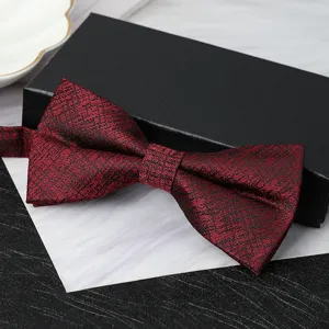 Close-up detail of the elegant burgundy textured bow tie showcasing refined craftsmanship.
