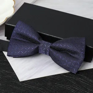 Dark blue patterned bow tie close-up detail, elegant men's formal neckwear accessory showcase.