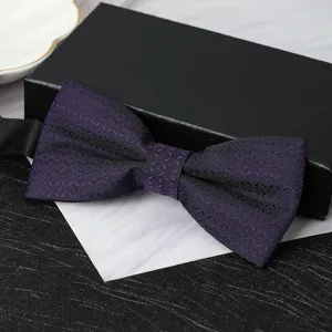 Detailed shot of a purple patterned men's bow tie with textured fabric and formal gift box.