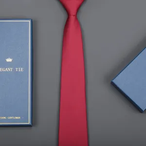 Detail view of a classic red business tie paired with a blue gift box, elegant and stylish.