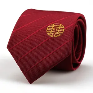 Close-up detail of a red men wedding necktie featuring gold embroidered double happiness motif.
