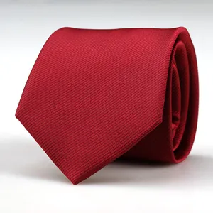 Close-up detail of a classic red men's business formal necktie with fine twill texture.