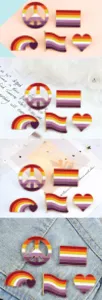 Close up detail view of cute pixel art pride flag alloy enamel pins for backpack and clothing.