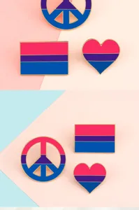 Close-up detail of colorful pride flag enamel pins in peace, heart, and flag shapes.