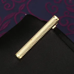 Close-up detail of the gold textured tie clip showcasing fine diagonal striped craftsmanship.