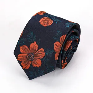 Detailed view of dark blue men tie featuring vibrant orange floral woven pattern elegant.