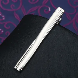 Silver metal tie clip for men, classic business formal accessory with geometric engraved ends.
