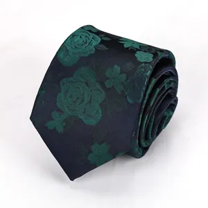 Detailed shot of a rolled dark necktie featuring green floral jacquard rose pattern.