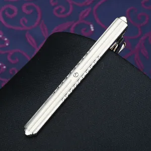 Detailed view of silver metal tie clip with rhinestones for men formal wear suit.