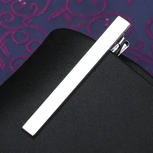 Stainless steel silver tie clip detail showing polished rectangular surface and clip mechanism.